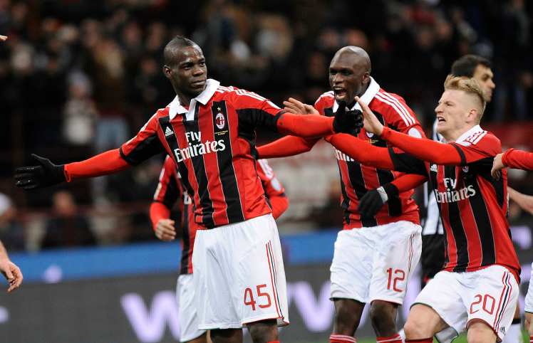 AC Milan's Balotelli celebrates with his team mates after scoring against Udinese during their Italian Serie A soccer match at the San Siro stadium in Milan
